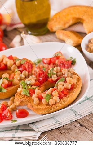 Friselle With Tomatoes And Chickpeas On White Dish.
