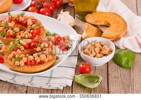 Friselle With Tomatoes And Chickpeas On White Dish.