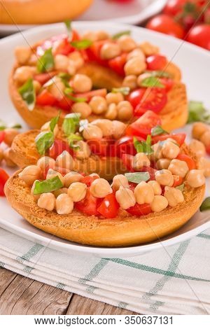 Friselle With Tomatoes And Chickpeas On White Dish.