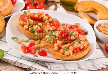 Friselle With Tomatoes And Chickpeas On White Dish.