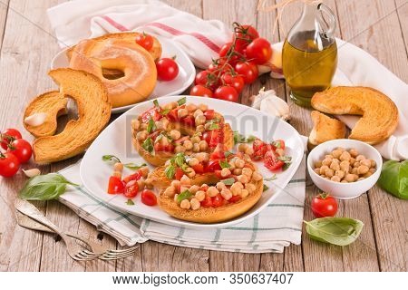 Friselle With Tomatoes And Chickpeas On White Dish.