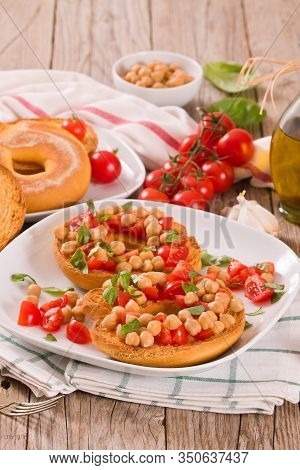 Friselle With Tomatoes And Chickpeas On White Dish.