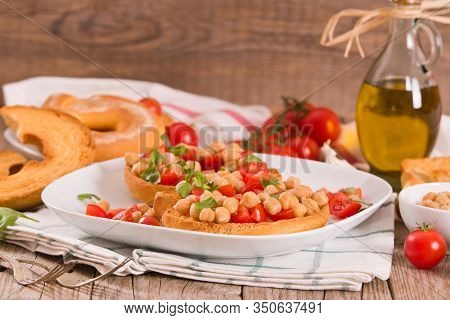 Friselle With Tomatoes And Chickpeas On White Dish.