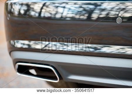 Selective Focus On Parking Sensor Exhaust Pipe Bumper At Rear Of Black Luxurious Car Bumper Close Up