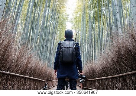 Young Man Traveling At Arashiyama Bamboo Grove, Happy Asian Traveler Looking Sagano Bamboo Forest. L