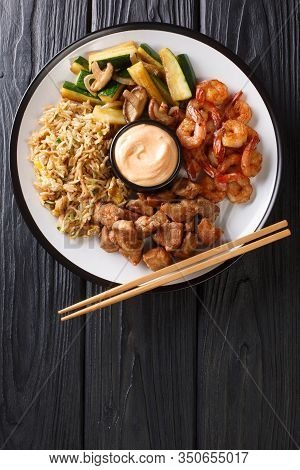 Hibachi Dish Consisting Of Fried Rice With Egg, Shrimp, Steak And Vegetables Served With Sauce Close