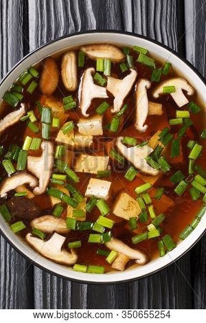 Japanese Miso Soup With Shiitake Mushrooms, Tofu And Green Onions Close-up In A Bowl. Vertical Top V