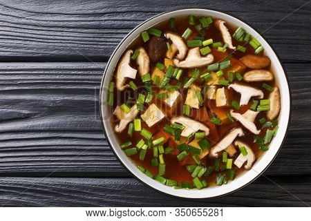 Asian Soup With Shiitake Mushrooms, Tofu Cheese And Green Onions Close-up In A Bowl. Horizontal Top