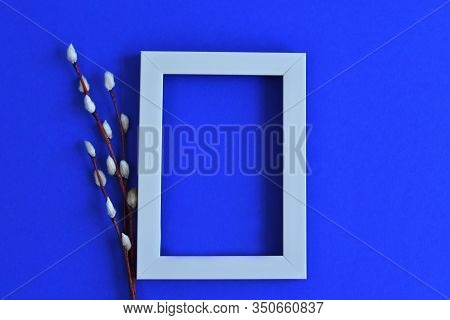 White Photo Frame And Pussy Willow Branches With Catkins On A Classik Blue Background.copy Space In 