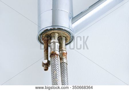 Old Rusty Pipe At The End Of A Water Tap On A White Background.