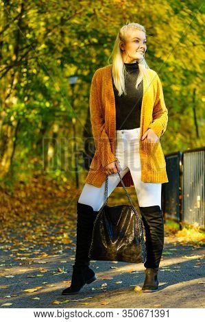 Woman Wearing Long Orange Warm Cardigan Sweater, White Tight Trousers Pants, High Knee Black Shoes A