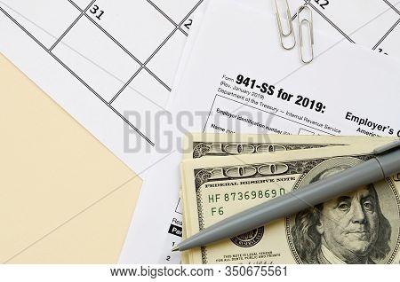 Irs Form 941-ss Employers Quarterly Federal Tax Return Blank Lies With Pen And Many Hundred Dollar B