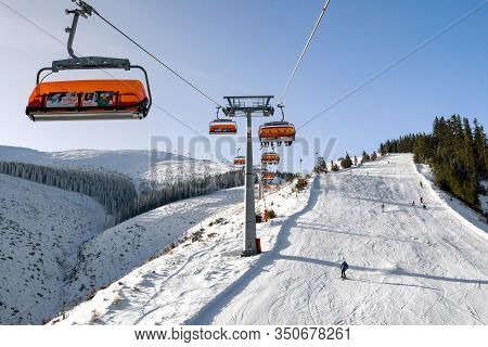 Demanovska Dolina, Slovakia - February 8: Skiers On Slope From Ski Lift Chair In Resort Jasna On Feb