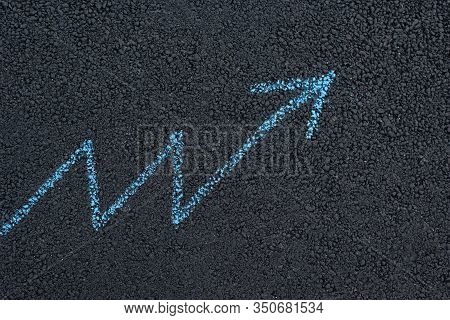 Drawing Arrows Underfoot. Texture Road Surface. Black Asphalt. Concept Of Growth.