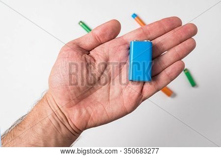 Blue Pp3 Battery In Male Hand On White Background. Accumulator.