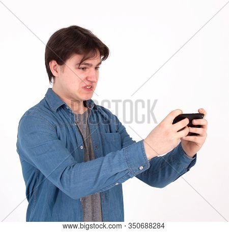 Angry Man Plays Mobile Game On His Smartphone.
