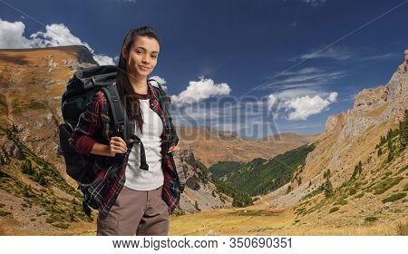 Young female hiker on a mountain with a backpack
