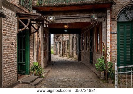 Gonzalez Catan, Argentina, September 28, 2019: Cobblestone Corridor Through Abandoned Buildings In T