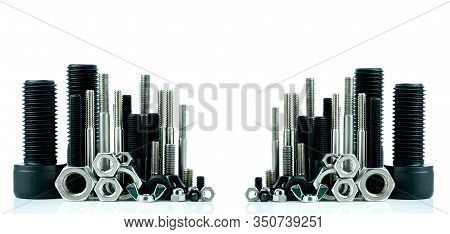 Metal Bolts And Nuts On White Background. Fasteners Equipment. Hardware Tools. Stud Bolt, Hex Nuts, 