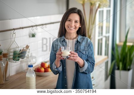 Young Woman Holding A Glass Of Joghurt
