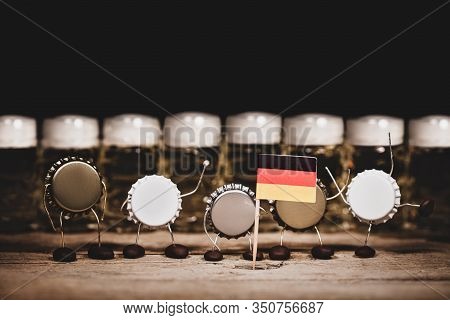 Crown Cork Miniature Figures And Beer Glasses In The Back, German Flag, Humorous Conceptual Scene Fo