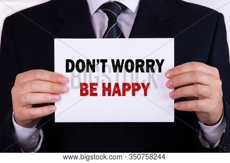 Businessman Holding A Card With Text Dont Worry Be Happy