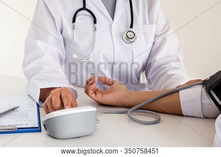 The Doctor Checks The Blood Pressure, The Patients Have An Initial Health Check And Talked About Hea