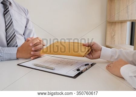 Businessmen Make An Agreement With Money In An Envelope Proposed To A Partner To Bribe In The Compan