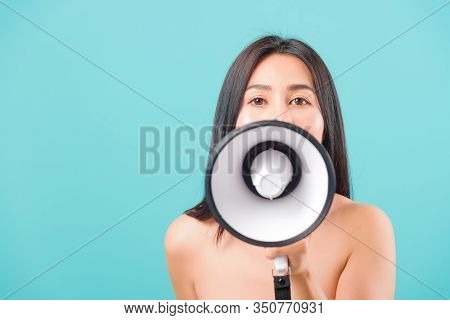 Smiling Face Portrait Asian Beautiful Woman Her Usring Megaphone On Blue Background, With Copy Space