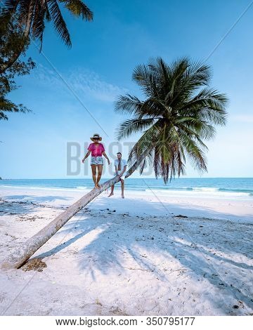 Wua Laen Beach Chumphon Area Thailand, Palm Tree Hanging Over The Beach With Couple On Vacation In T