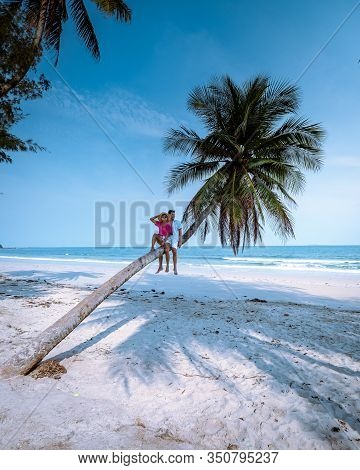 Wua Laen Beach Chumphon Area Thailand, Palm Tree Hanging Over The Beach With Couple On Vacation In T