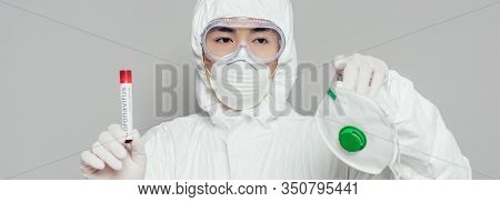 Panoramic Shot Of Asian Epidemiologist Showing Respirator Mask And Test Tube With Blood Sample Isola
