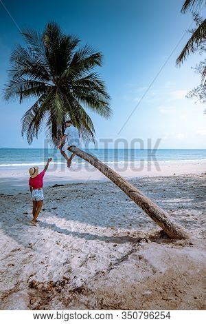 Wua Laen Beach Chumphon Area Thailand, Palm Tree Hanging Over The Beach With Couple On Vacation In T