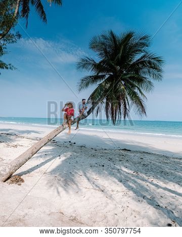 Wua Laen Beach Chumphon Area Thailand, Palm Tree Hanging Over The Beach With Couple On Vacation In T