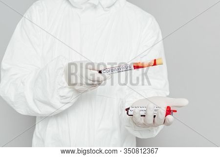 Cropped View Of Epidemiologist In Hazmat Suit Holding Test Tubes With Blood Samples Isolated On Grey