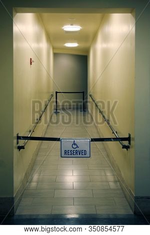 Hallway. Handy Cap Access Hallway. Closed off hallway with Handy Cap access sign. Interior walkway of a building in Los Angeles California. 