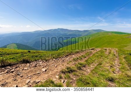 Green Rolling Hills Of Mountain Ridge Borzhava. Grassy Alpine Meadows Beneath A Blue Sky With Some C