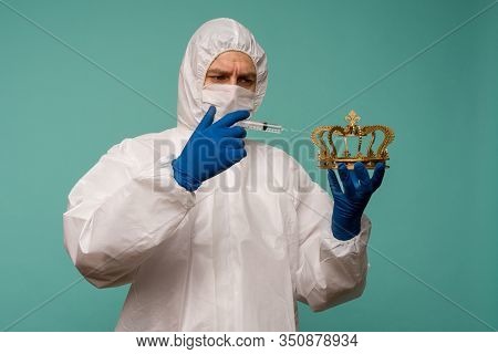 A Male Doctor In Protective Overalls And A Mask Makes An Injection In The Crown. Coronovirus Protect