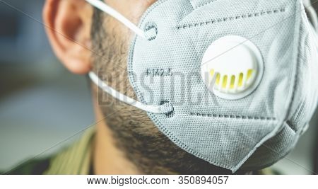 Wearing Mask To Protect Pm 2.5 Dust And Air Pollution. Close Up Of Thai Man Wearing Protection Mask 