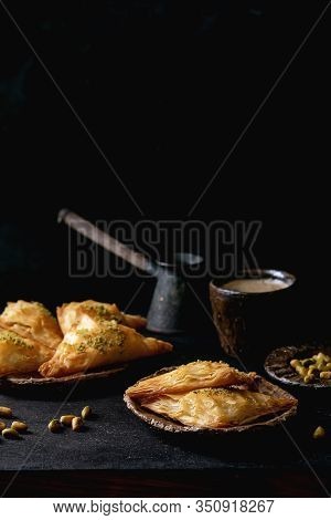 Homemade Turkish Traditional Dessert Baklava With Pistachio Served On Ceramic Plate With Bowl Of Nut