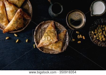 Homemade Turkish Traditional Dessert Baklava With Pistachio Served On Ceramic Plate With Bowl Of Nut