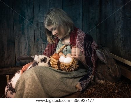 Portrait Of A Little Girl With Eggs And Rabbits In The Village In The Hayloft