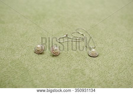 Jewelry For The Bride: Earrings And A Pendant With A Chain On A Green Swamp Background