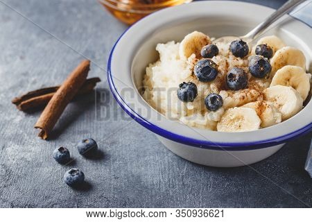 Milk Rice Porridge With Blueberry, Banana, Honey And Cinnamon, Creamy Rice Pudding Or French Riz Au 
