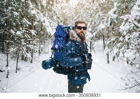 Male Hiker On A Winter Forest Snow-clad Path
