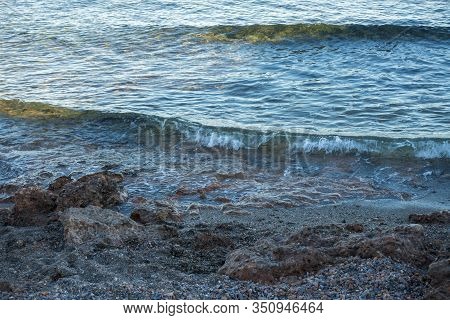 Calm Waves On The Shore Of The Blue Sea