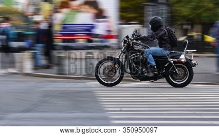 Bucharest, Romania - October 11, 2018: A Harley-Davidson XL883R Sportster 883 Roadster chopper motorcycle passes with speed on a Boulevard in Bucharest. For editorial use only