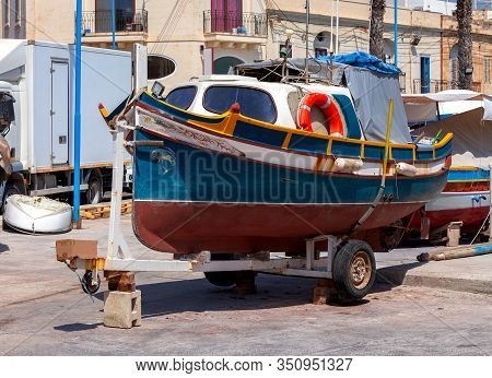 Multicolored Fishing Boats Luzzu With Eyes In The Harbor. Marsaxlokk. Malta.