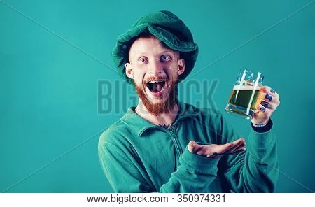 Patricks Day Party. Portrait Of Excited Man Holding Glass Of Beer On St Patricks Day Isolated On Gre