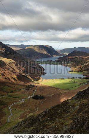 Epic Autumn Fall Landscape Of Buttermere And Crummock Water Surrounded By Mountain Peaks In Lake Dis